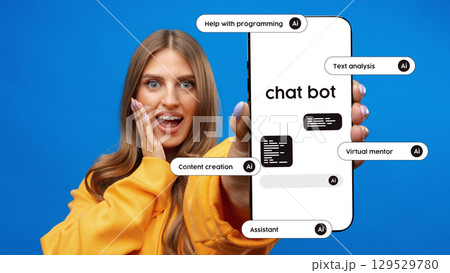Excited user showcasing chatbot capabilities with smartphone against bright blue background Excited user showcasing chatbot capabilities with smartphone against bright blue background 129529780