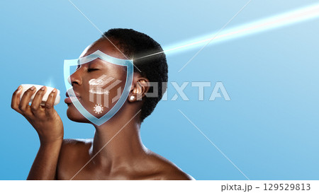 Woman applying skincare product, enjoying self-care in a bright, serene setting during daytime 129529813