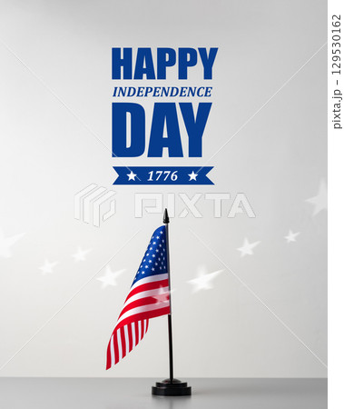 Celebrating Independence Day with an American flag displayed against a simple backdrop 129530162