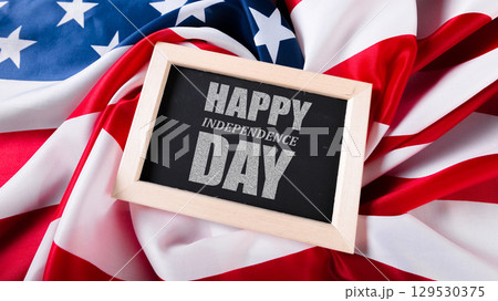 Celebrating Independence Day with a festive message on a backdrop of the American flag Celebrating Independence Day with a festive message on a backdrop of the American flag 129530375