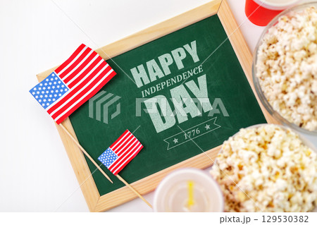 Celebrating Independence Day with popcorn and festive decorations in a cheerful setting 129530382