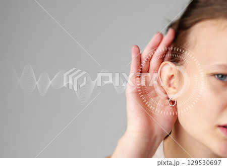 Conceptual illustration of a woman listening attentively with sound waves representing clear sound communication 129530697