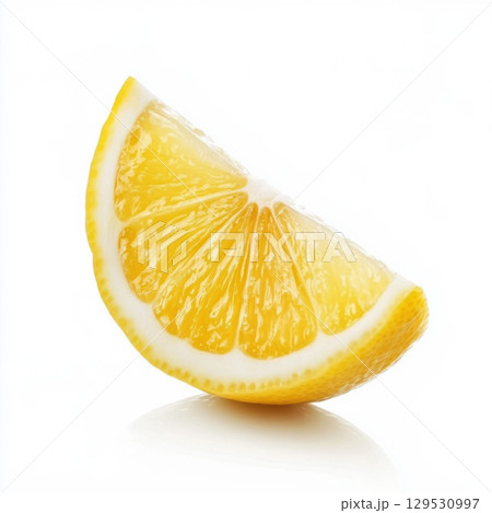 Close-up of a fresh lemon wedge with white background. 129530997