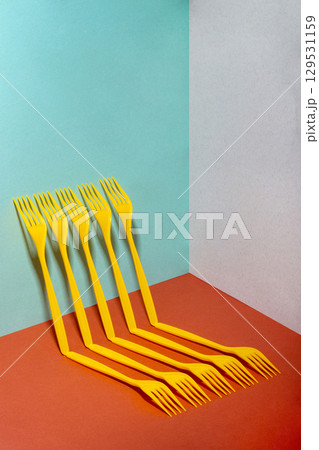 Abstract still life with yellow forks on a colorful background 129531159