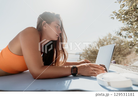 Young Woman Working on Laptop on a Sunny Day Young Woman Working on Laptop on a Sunny Day 129531181