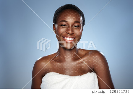 Smiling woman in towel with glowing skin against a soft blue background highlighting beauty and self-care Smiling woman in towel with glowing skin against a soft blue background highlighting beauty and self-care 129531725