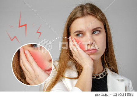 Feeling pain in the cheek area during a dental issue with a worried expression and hand on face Feeling pain in the cheek area during a dental issue with a worried expression and hand on face 129531889