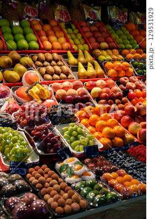 Vibrant fruit display at a bustling market during daylight in a lively urban setting 129531929
