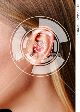 Close-up view of a woman's ear with digital sound wave representation in a modern setting during daylight hours Close-up view of a woman's ear with digital sound wave representation in a modern setting during daylight hours 129532018