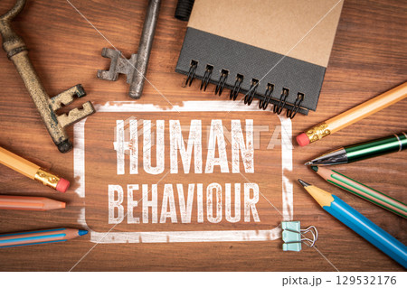 Human Behaviour Analysis Concept with Keys, Notebook, and Office Supplies on Wooden Desk Human Behaviour Analysis Concept with Keys, Notebook, and Office Supplies on Wooden Desk 129532176