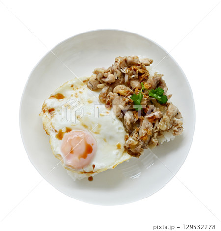 Thai basil chicken with fried egg on a white plate Thai basil chicken with fried egg on a white plate 129532278