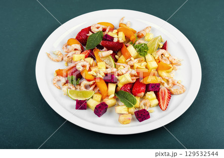 Tasty seafood salad and exotic fruits. Tasty seafood salad and exotic fruits. 129532544