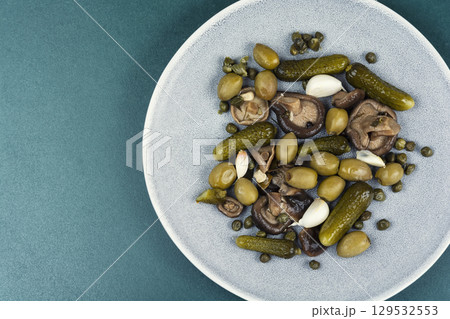 Plate with salty snacks. 129532553