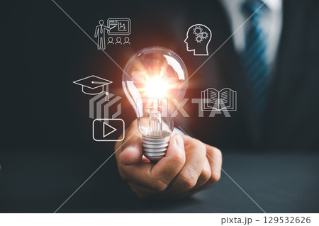 Learn technology, knowledge and e-learning skills through online courses, as a lightbulb represents new ideas where we learn from books, video, teaching and mental processing online 129532626