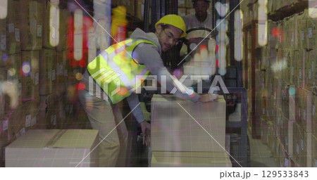 Image of caucasian male warehouse worker over blurred night city 129533843