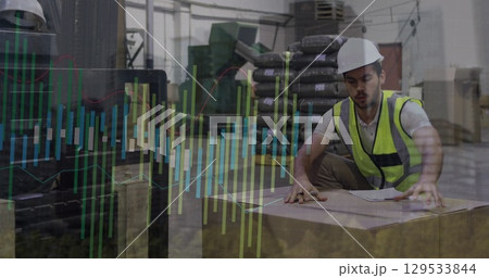 Image of male warehouse worker over graphs 129533844