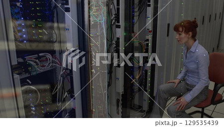 Image of data processing against caucasian female engineer working at server room Image of data processing against caucasian female engineer working at server room 129535439
