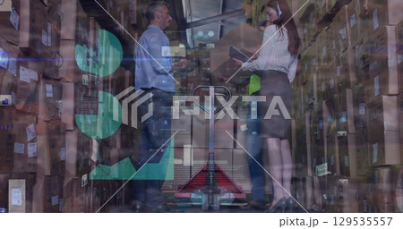 Image of caucasian female and male warehouse workers over graphs 129535557