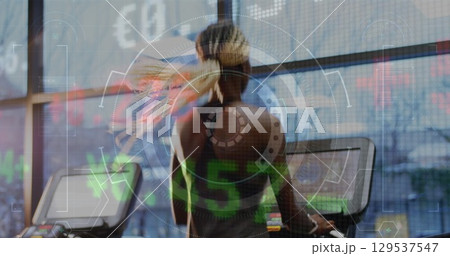 Image of graphs and financial data over back view of african american woman on treadmill 129537547