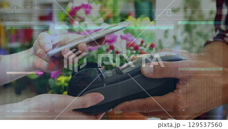 Image of financial data over hands of diverse people using payment terminal 129537560