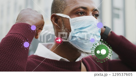 Image of flag of canada waving over woman in face masks 129537605