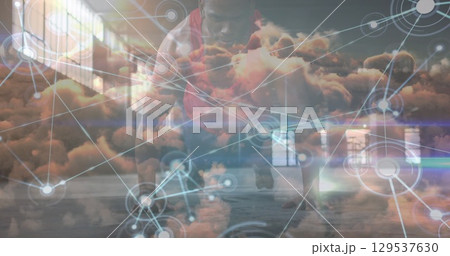 Network of digital icons over clouds in the sky against african american fit man performing push ups Network of digital icons over clouds in the sky against african american fit man performing push ups 129537630