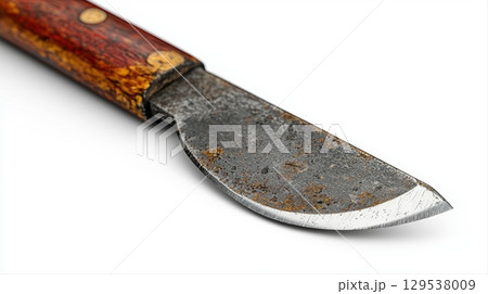 weathered knife rusty blade and worn wooden handle is positioned on clean neutral surface highlighting its aged appearance and texture. 129538009