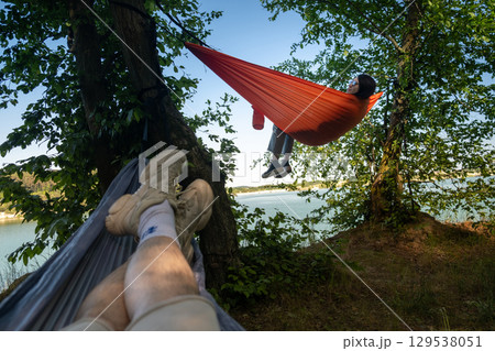 Relaxing in Hammocks by the Lake 129538051
