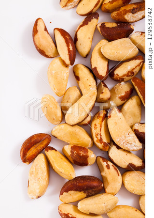 Brazilian nut scattered on white surface Brazilian nut scattered on white surface 129538742