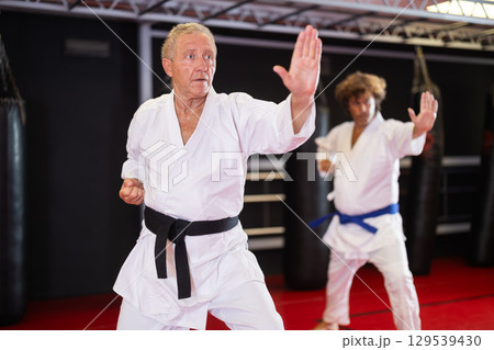 Man with other athletes of different ages during karate classes 129539430