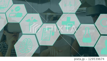 Image of medical icons over diverse people using vr headsets 129539674