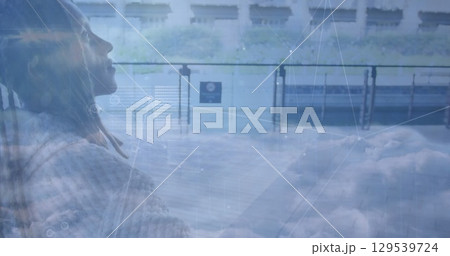 Image of network of connections and sky with clouds over african american man riding bike Image of network of connections and sky with clouds over african american man riding bike 129539724