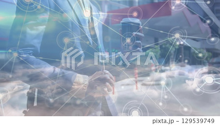 Image of network of connections over clouds and legs of caucasian businessman 129539749