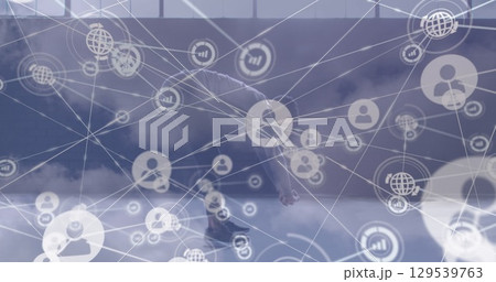 Image of network of connections over clouds and african american man exercising 129539763