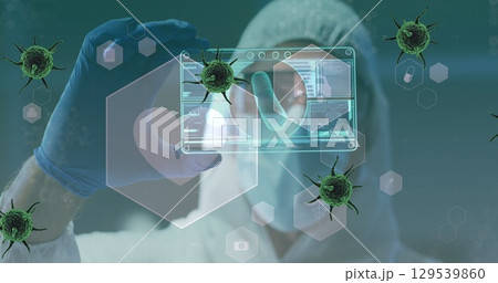 Image of green virus cells over caucasian male lab worker in safety clothes with digital card 129539860