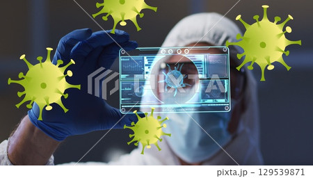 Image of yellow virus cells over caucasian male lab worker in safety clothes with digital card 129539871
