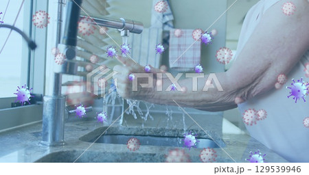 Image of purple virus cells over hands pf caucasian senior man washing hands 129539946