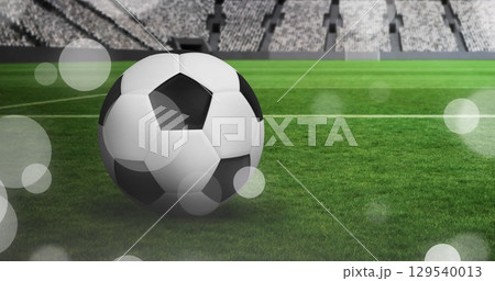 Image of glowing falling dots over football stadium Image of glowing falling dots over football stadium 129540013