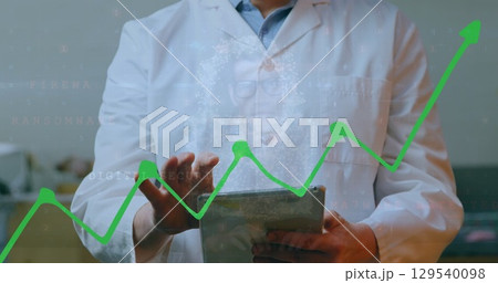 Image of financial graph over worker using tablet 129540098