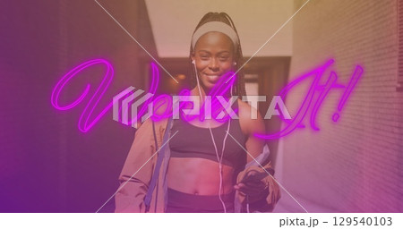 Image of work it over happy african american woman listening music during training 129540103
