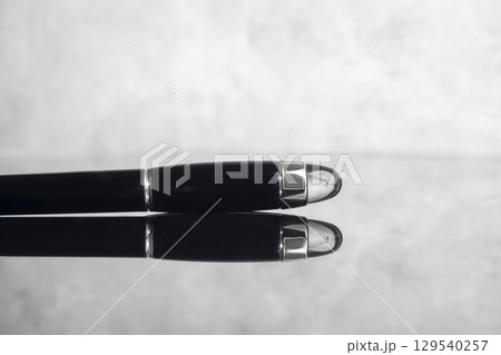 Branded fountain pen on marble gray background. Gift set. Office interior. 129540257