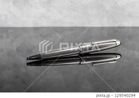 Branded fountain pen on marble gray background. Gift set. Office interior. 129540294