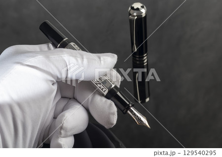 Branded fountain pen on marble gray background. Gift set. Office interior. Branded fountain pen on marble gray background. Gift set. Office interior. 129540295