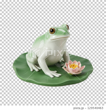 Elegant porcelain frog figurine resting on a green lily pad with a delicate pink lotus flower 129540463