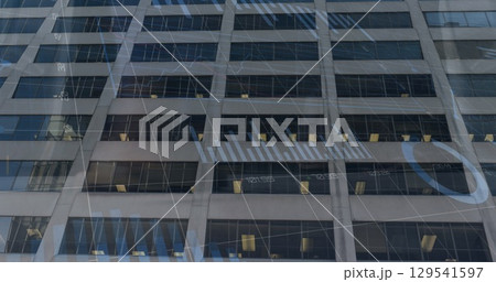 Image of financial graphs and data over office building 129541597