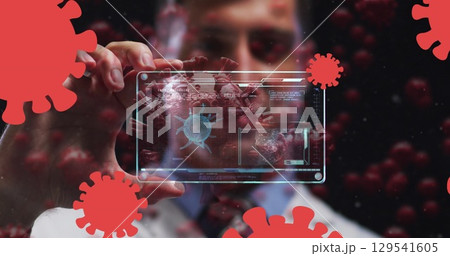 Image of coronavirus cells over male doctor holding clear tablet processing data about cell Image of coronavirus cells over male doctor holding clear tablet processing data about cell 129541605