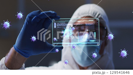 Image of purple virus cells over caucasian male lab worker in safety clothes with digital card 129541646