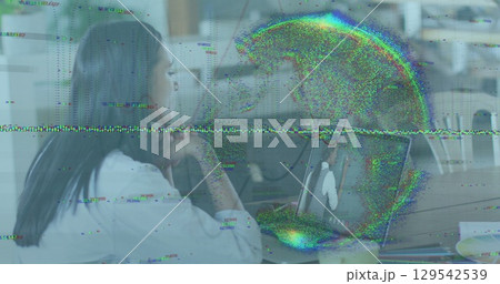 Image of data processing and globe over businesswoman using laptop Image of data processing and globe over businesswoman using laptop 129542539