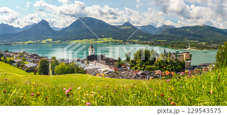 Sankt Wolfgang on Lake Wolfgangsee, panoramic view from a meadow of the landscape with the town, lake, and mountains, Austria 129543575