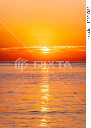 Beautiful red and orange sunrise over the sea. Beautiful red and orange sunrise over the sea. 129543834